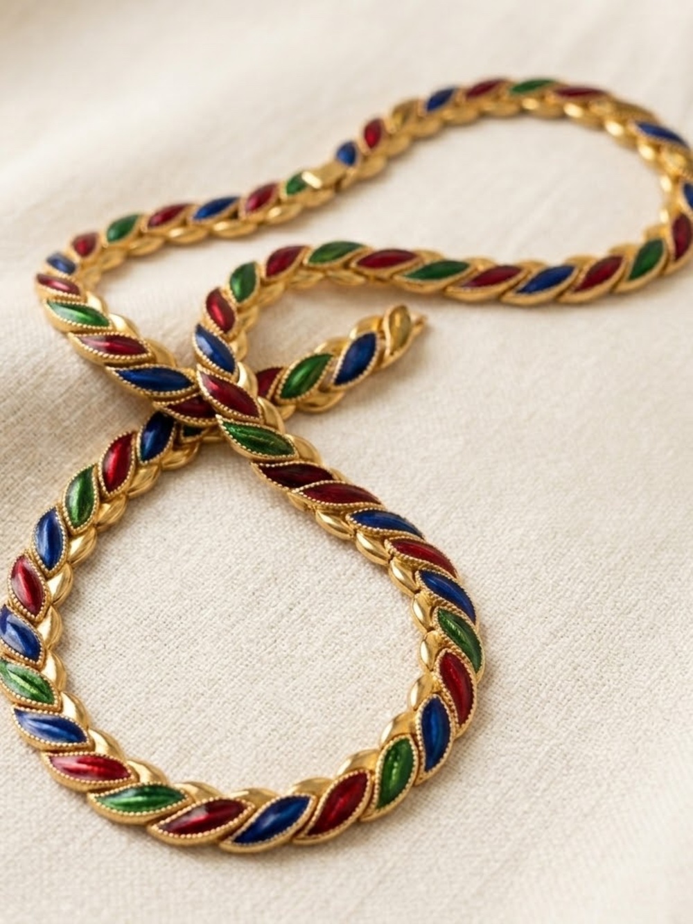 Vintage gold-tone metal necklace with multi-color enamel leaf detail